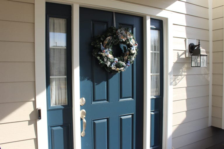 blue front door with a wreath