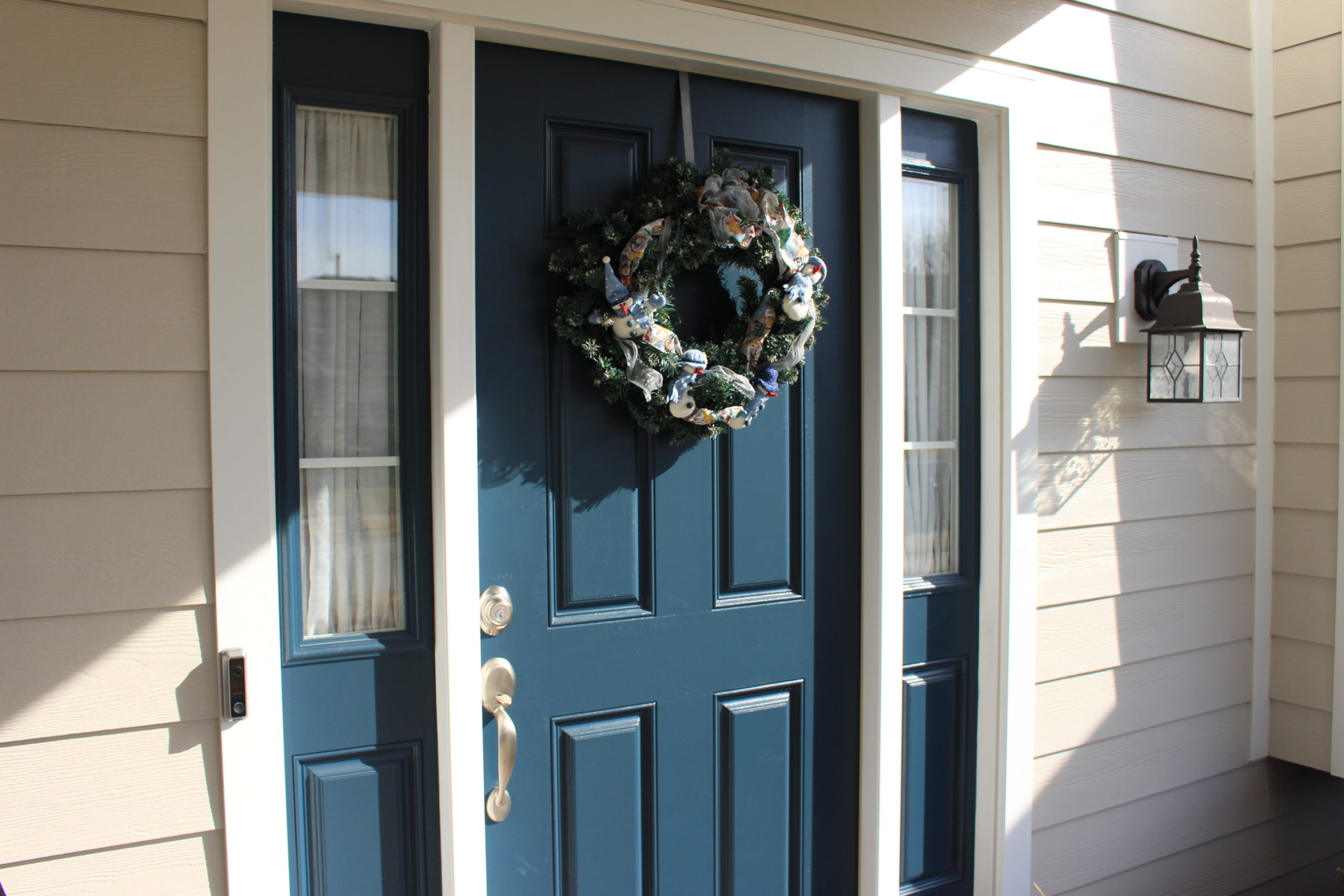 blue front door with a wreath